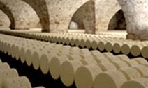An underground warehouse of cheese wheels.
